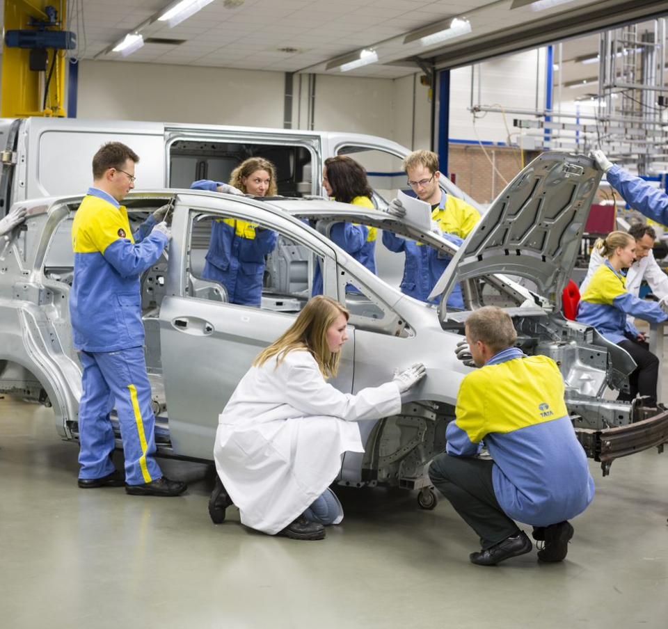 Several Tata Steel technicians working on a car frame